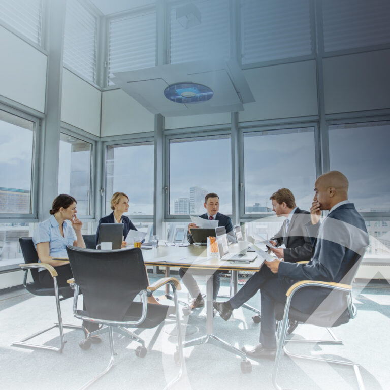 5 professional business people sitting around a conference table